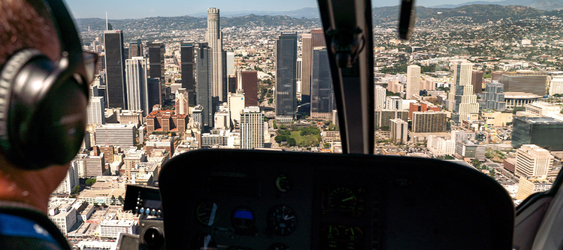 Pilot's view of the downtown Los Angeles skyline from inside a Maverick helicopter cockpit