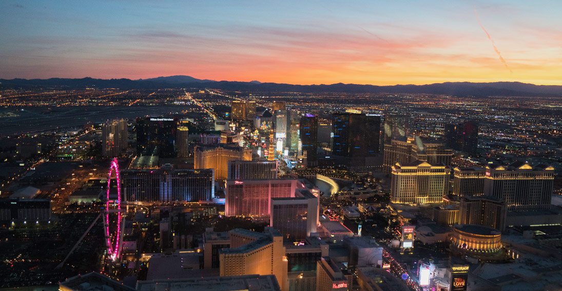 A view of desert sunset and neon lights of Las Vegas on your return flight